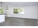 Modern dining room with gray vinyl flooring and an open concept feel at 9085 Dorsey St, Spring Hill, FL 34608