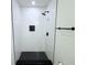 Modern shower with black accents and hexagon tile floor at 9085 Dorsey St, Spring Hill, FL 34608