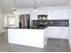 Modern kitchen with stainless steel appliances and white shaker cabinets at 9085 Dorsey St, Spring Hill, FL 34608
