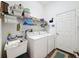 Well-lit laundry room, washer, dryer, and ample storage at 3002 Minuteman Ln, Brandon, FL 33511