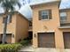 Exterior view of tan townhouse with garage at 9629 Trumpet Vine Loop, Trinity, FL 34655