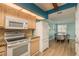 Kitchen with light wood cabinets, granite countertops, and white appliances at 1500 Mahogany Ln # 605, Palm Harbor, FL 34683