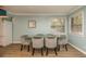 Dining area featuring a glass-top table and six gray chairs at 1500 Mahogany Ln # 605, Palm Harbor, FL 34683