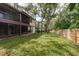 Side yard with grassy area and wooden fence at 1500 Mahogany Ln # 605, Palm Harbor, FL 34683