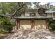 Two-car garage with brick facade and a green metal roof at 1500 Mahogany Ln # 605, Palm Harbor, FL 34683