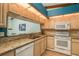 Kitchen with light wood cabinets, granite countertops, and white appliances at 1500 Mahogany Ln # 605, Palm Harbor, FL 34683