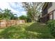 Spacious backyard with a wooden fence and mature trees at 1500 Mahogany Ln # 605, Palm Harbor, FL 34683