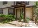 Inviting front entrance with lush landscaping and a charming brick walkway at 1500 Mahogany Ln # 605, Palm Harbor, FL 34683