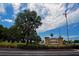 Kings Point community entrance with lush landscaping and flag at 304 Kelsey Way # 2, Sun City Center, FL 33573