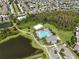 Community lap pool and clubhouse near homes and lake at 1523 Glen Grove Loop, Wesley Chapel, FL 33543
