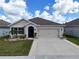 One-story house with a two-car garage and well-maintained lawn at 1523 Glen Grove Loop, Wesley Chapel, FL 33543