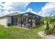Spacious screened patio with seating area and backyard view at 1523 Glen Grove Loop, Wesley Chapel, FL 33543