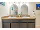 Elegant bathroom with double sinks and arched mirrors at 1523 Glen Grove Loop, Wesley Chapel, FL 33543