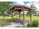 Wooden covered picnic table with benches in a neighborhood park at 1523 Glen Grove Loop, Wesley Chapel, FL 33543