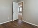 Bedroom with wood-look flooring and access to another room at 2126 Richwood Pike Dr, Ruskin, FL 33570