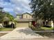 Two-story house with a two-car garage and a red front door at 2126 Richwood Pike Dr, Ruskin, FL 33570