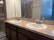 Double vanity bathroom with a large mirror and shower at 2126 Richwood Pike Dr, Ruskin, FL 33570