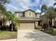 Two-story house with a two-car garage and a red front door at 2126 Richwood Pike Dr, Ruskin, FL 33570