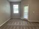 Spacious bedroom with carpet, window, and sliding glass door at 2126 Richwood Pike Dr, Ruskin, FL 33570