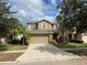 Two-story house with a two-car garage and a red front door at 2126 Richwood Pike Dr, Ruskin, FL 33570