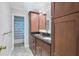 Bathroom featuring a double sink vanity with dark wood cabinets and a shower with blue curtain at 1229 S Roxmere Rd, Tampa, FL 33629