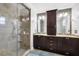 Modern bathroom featuring a glass shower and and sinks with dark wood cabinetry at 1229 S Roxmere Rd, Tampa, FL 33629