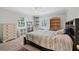Comfortable bedroom with neutral walls, ceiling fan and a large window at 1229 S Roxmere Rd, Tampa, FL 33629