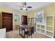 Bedroom with yellow walls, carpeted floor, ceiling fan, and multiple shelves and desks at 1229 S Roxmere Rd, Tampa, FL 33629