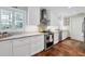 Modern kitchen with stainless steel appliances and beautiful hardwood floors at 1229 S Roxmere Rd, Tampa, FL 33629