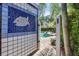 Mosaic tile art wall with shower next to pool surrounded by palm trees and green shrubs at 1229 S Roxmere Rd, Tampa, FL 33629