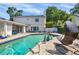 In-ground pool with brick pavers and an outdoor lounge area for relaxing and entertaining at 1229 S Roxmere Rd, Tampa, FL 33629