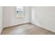 Bright bedroom featuring light wood floors and a view from the window at 13719 Brookside Haven St, Riverview, FL 33578
