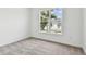 Bright bedroom with large window providing view of palm trees and neighborhood at 13719 Brookside Haven St, Riverview, FL 33578