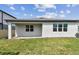 Exterior view of the home featuring a well-maintained lawn and privacy fence at 13719 Brookside Haven St, Riverview, FL 33578