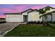 Charming one-story home with a well-kept lawn, driveway, and a colorful sunset at 13719 Brookside Haven St, Riverview, FL 33578