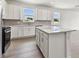 Well-equipped kitchen with modern appliances, island, and plenty of cabinet space at 13719 Brookside Haven St, Riverview, FL 33578