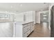 Kitchen island with white countertops and cabinetry in an open space at 13719 Brookside Haven St, Riverview, FL 33578