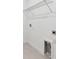 Bright laundry room with a metal shelving unit for storage and tile floors at 13719 Brookside Haven St, Riverview, FL 33578