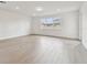 Spacious and bright living room with hardwood floors and large windows at 13719 Brookside Haven St, Riverview, FL 33578