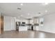 Open floor plan showcasing a spacious living area, kitchen with stainless steel appliances and a kitchen island at 13719 Brookside Haven St, Riverview, FL 33578