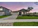 Charming home featuring a driveway, garage, and manicured lawn at 13730 Evergreen Valley Dr, Riverview, FL 33578
