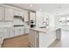 Bright, modern kitchen with white cabinets, stainless steel appliances, and a large center island at 13730 Evergreen Valley Dr, Riverview, FL 33578