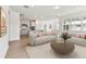 Bright and airy living room with hardwood floors, modern sofas and open floor plan to the kitchen at 13730 Evergreen Valley Dr, Riverview, FL 33578