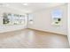 Open concept living space with large windows providing natural light and wood-look flooring at 13730 Evergreen Valley Dr, Riverview, FL 33578