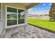 A covered patio with brick pavers and a view of the backyard at 13730 Evergreen Valley Dr, Riverview, FL 33578
