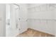 Bright walk-in closet features shelving, a door, and neutral carpet at 13730 Evergreen Valley Dr, Riverview, FL 33578