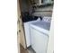 Convenient laundry area features a modern washer and dryer, located just off the garage at 241 Skiff Pt # 4, Clearwater Beach, FL 33767
