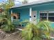 Teal building with a porch, tropical plants, and a walkway at 412 73Rd Ave, St Pete Beach, FL 33706