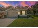 Two-story house with tan exterior and a two-car garage at 656 Spring Lake W Cir, Tarpon Springs, FL 34688