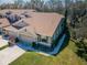 Tan house with brown roof and a two car garage at 656 Spring Lake W Cir, Tarpon Springs, FL 34688